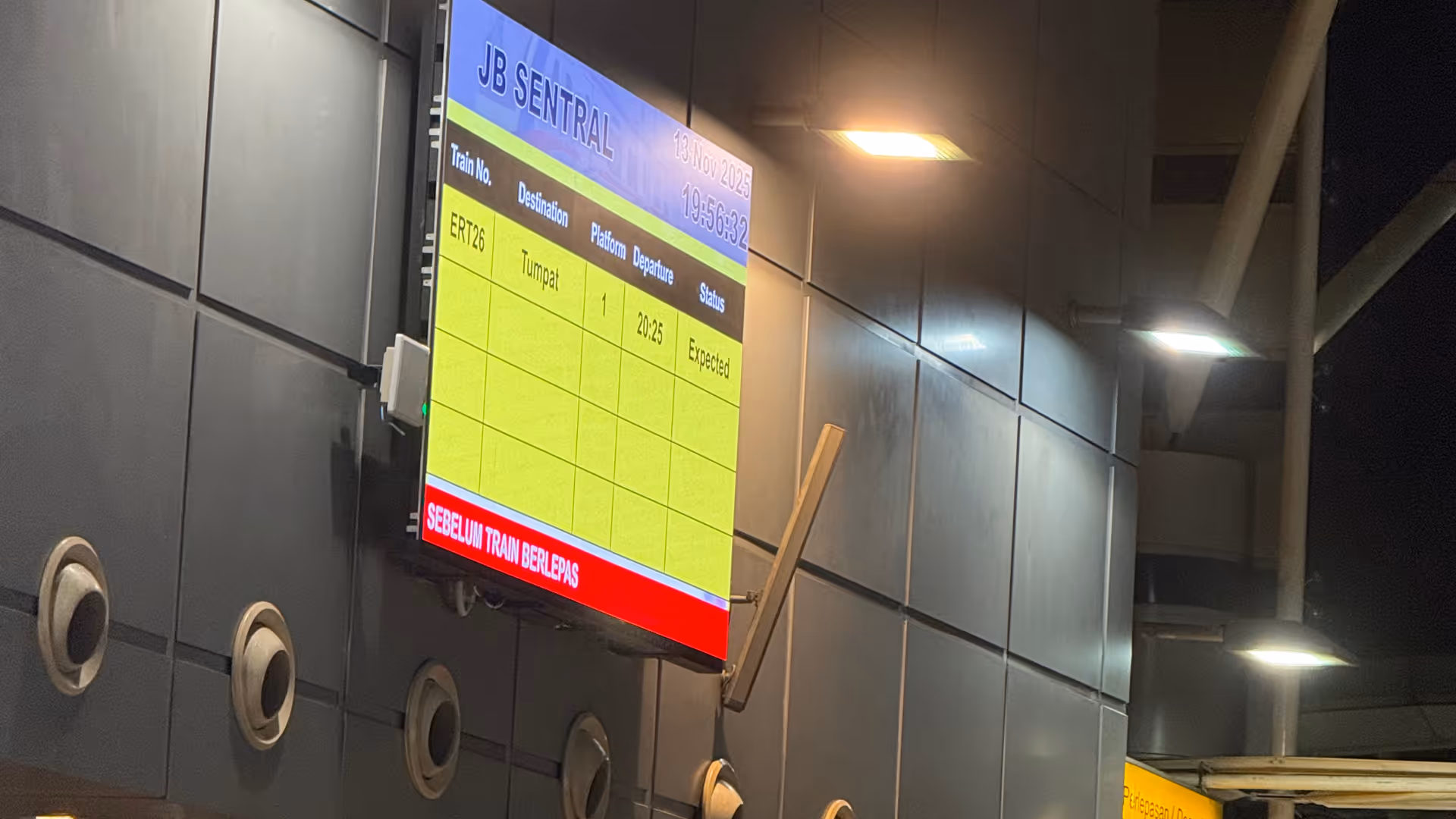 The digital departure board at JB Sentral showing the 20:25 train to Tumpat.