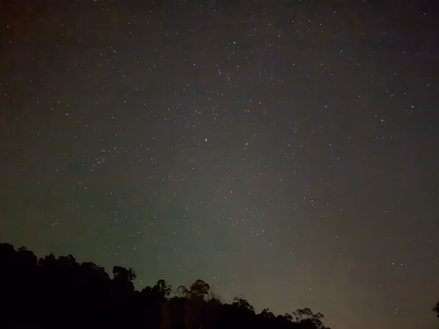 The white dome of an observatory open to the night sky
