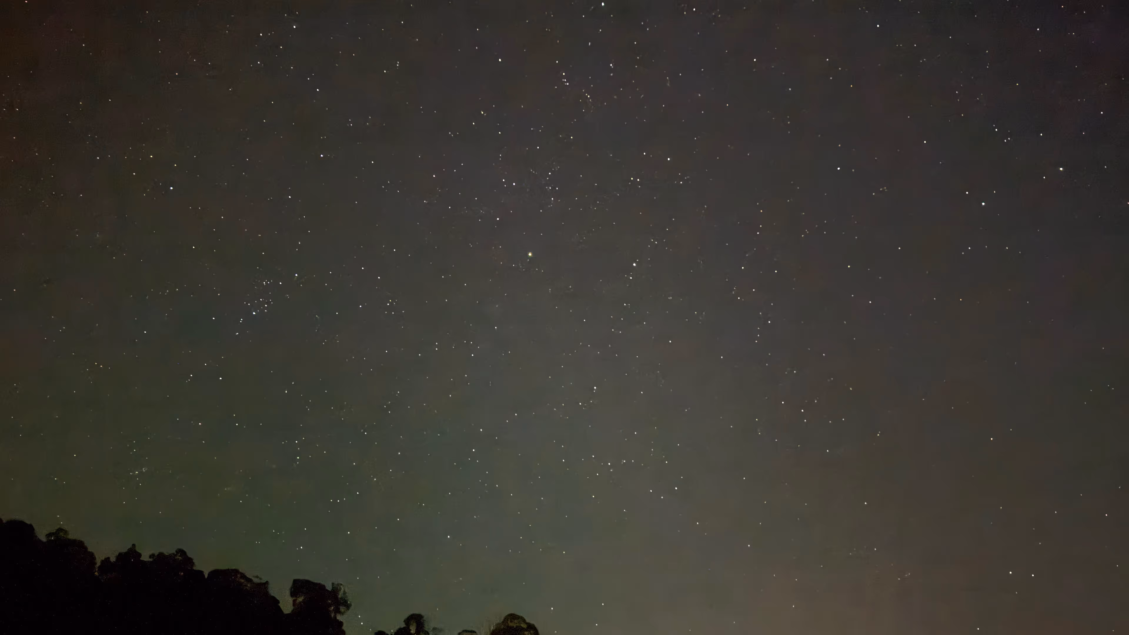 The white dome of an observatory open to the night sky